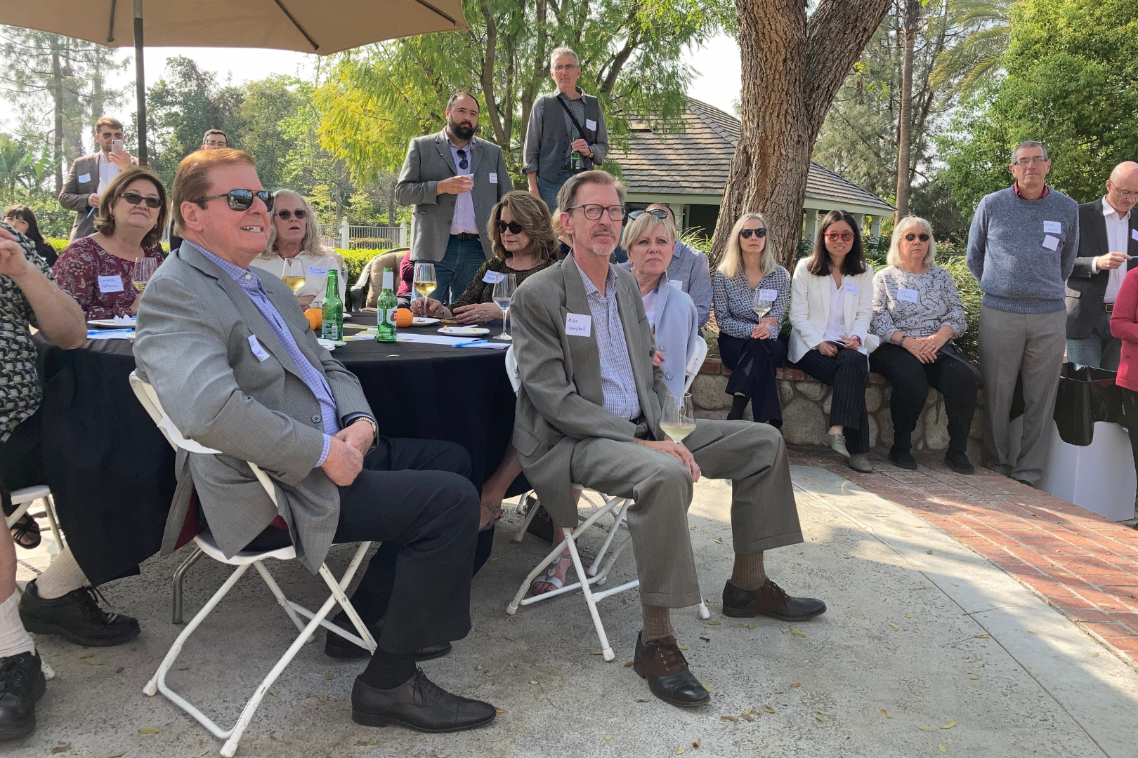 Colleagues, friends, and family listen to remarks from Van Den Berg and Payne.