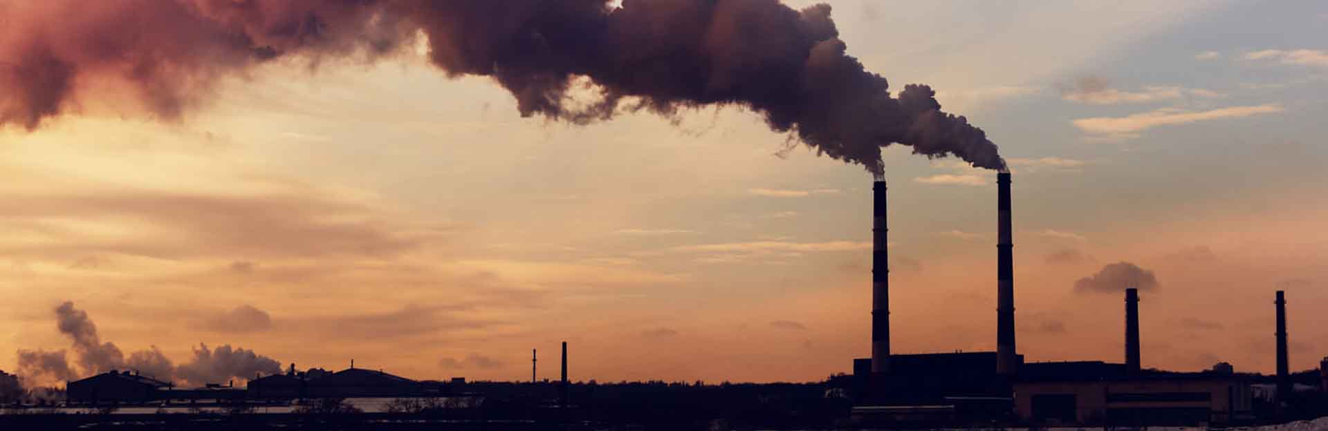 Two smokestacks exuding pollution