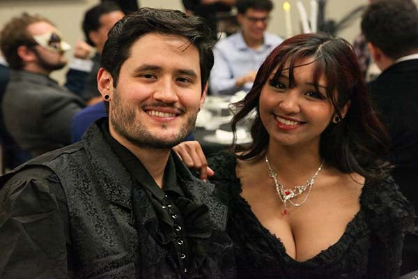 2025 Masquerade Gala man and woman dressed in formal attire 