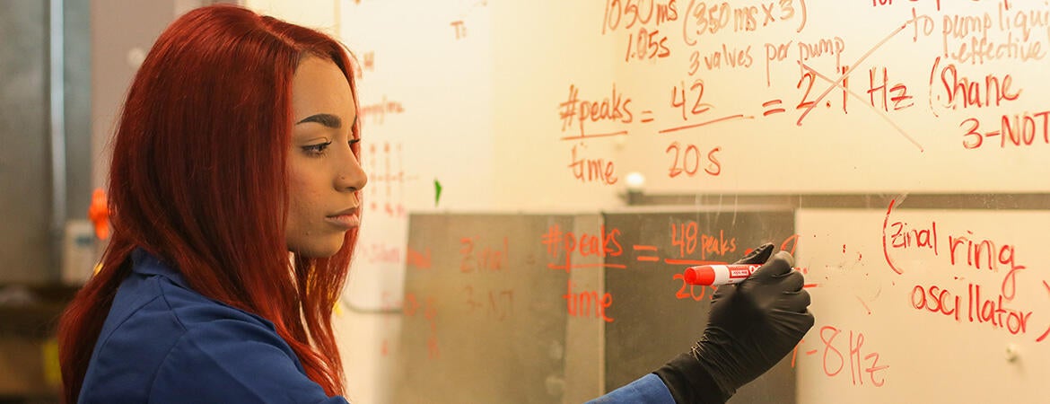 UCR BCOE bioengineering doctoral student Samantha Robinson writing on a dry erase board.