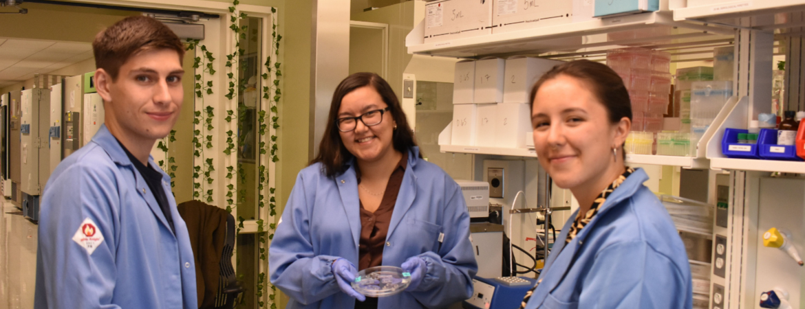 Three student researchers in the lab