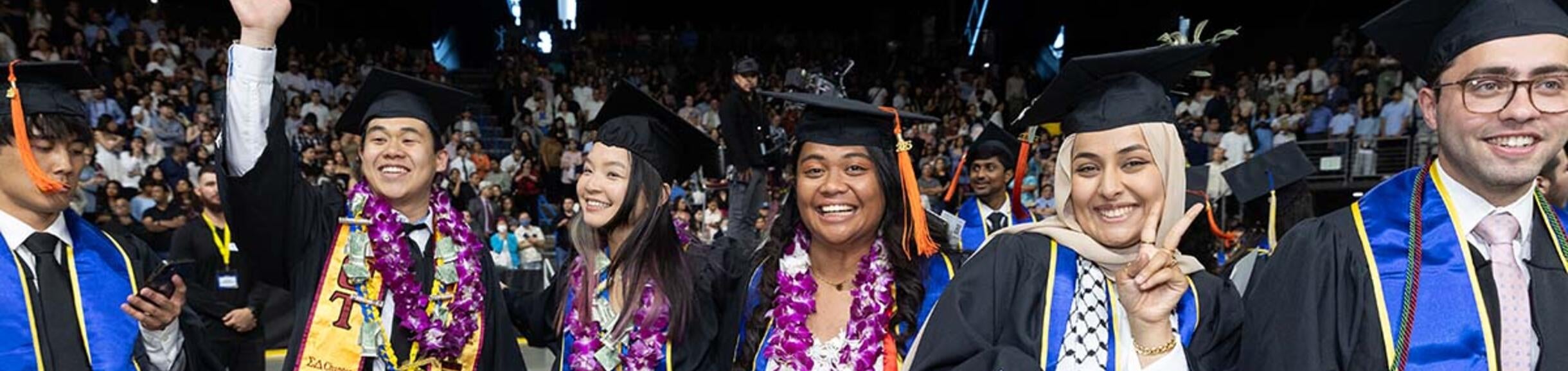 men and women in graduation regalia