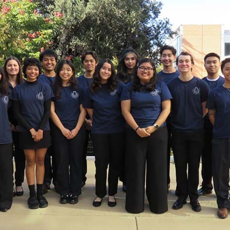 BMES women and men dressed in the black pants and branded navy t-shirts 