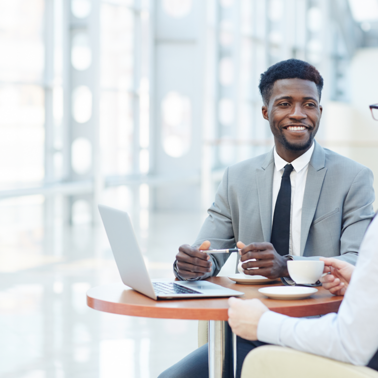 2 men at small conference table