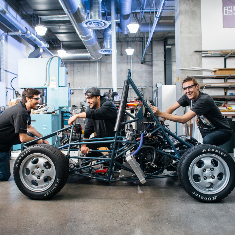 student working on car