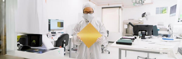 A technician holds a wafer-scale GPU computer chip. 