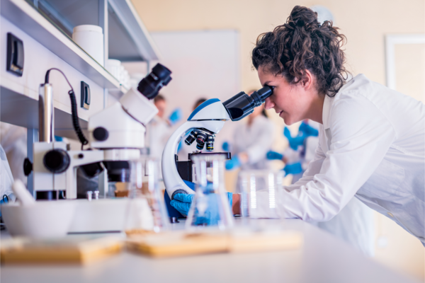 woman looking in microscope