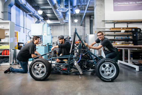 student working on car