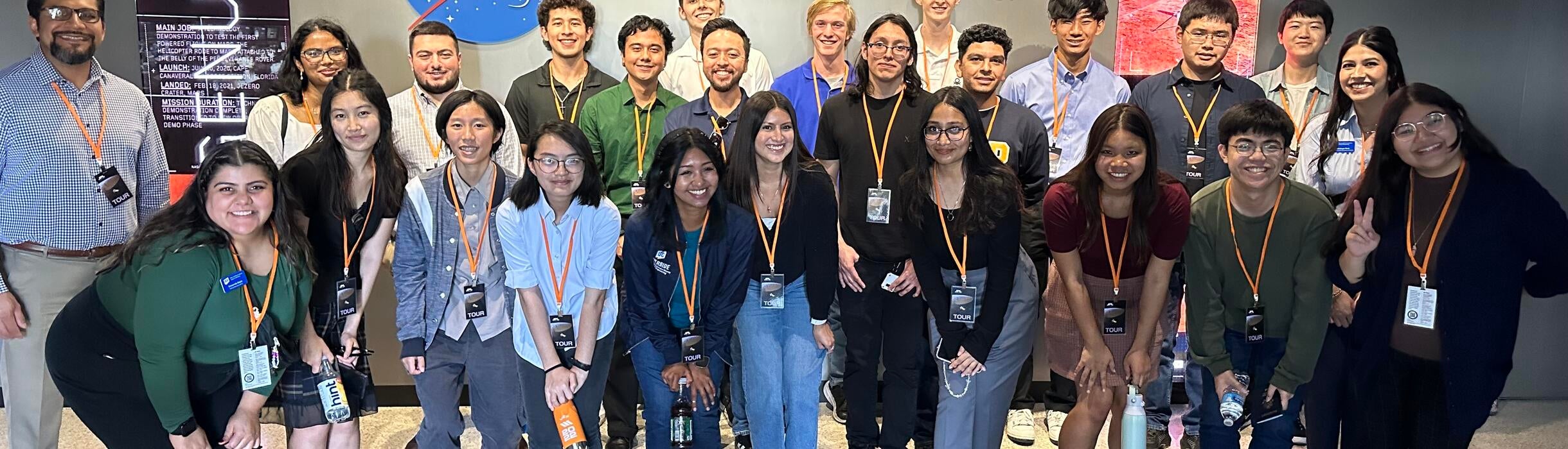 group of BCOE engineering students posing in front of the Nasa JPL building sign   