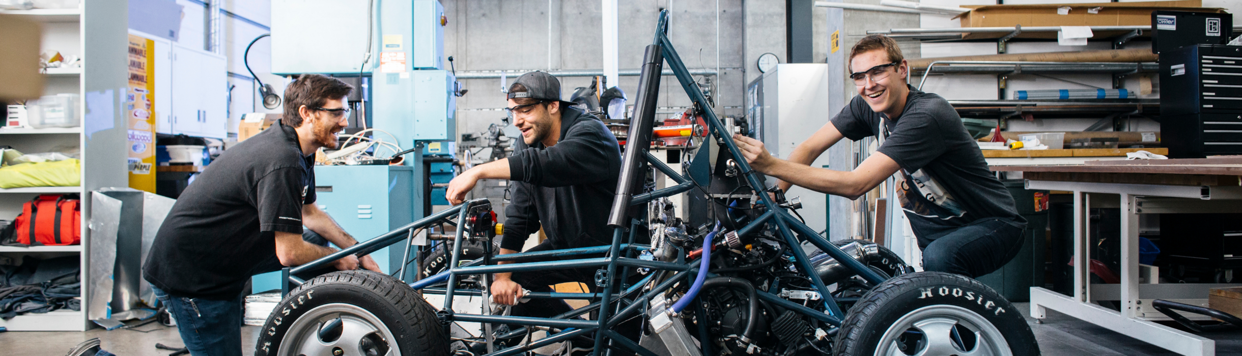 student working on car