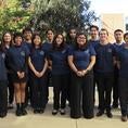 BMES women and men dressed in the black pants and branded navy t-shirts 
